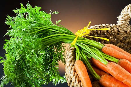 nuts and carrots in the basket の写真素材
