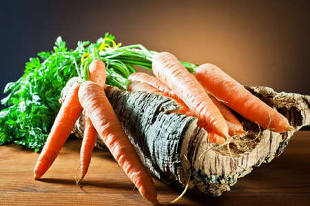 carrots on tree bark の写真素材