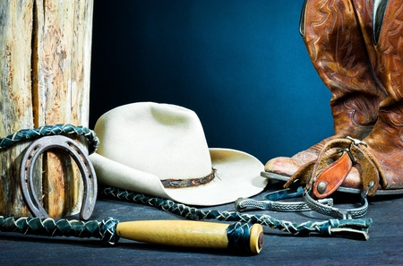 Cowboy boots,horseshoe,whip,spurs and hat on wood の写真素材