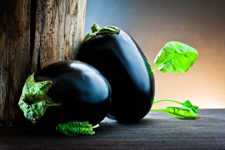 aubergine and spinach on wood の写真素材