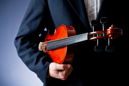 a man with his clothes and his violinの写真素材