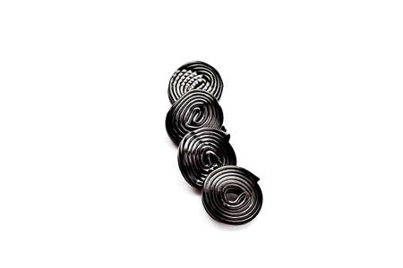 rolls of liquorice isolated on whiteの写真素材