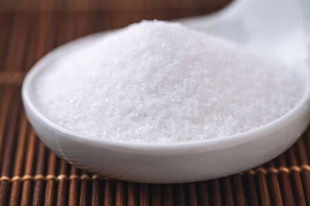 refined white sugar in a bowl on backgroundの写真素材
