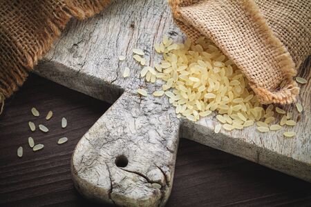 brown rice on cutting boardの写真素材