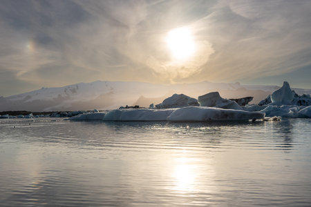 Sunset over horizon of icebergsの写真素材