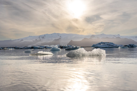 Sunset over horizon of icebergsの写真素材