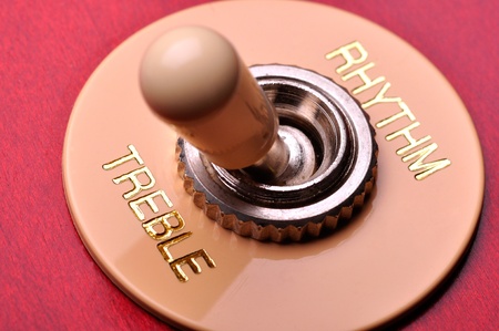 Closeup of a red electric guitar near the humbucker selector