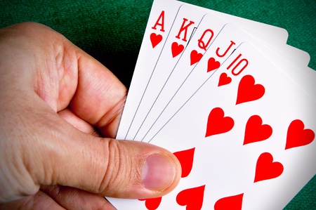 Hand holding a Royal Flush poker card sequenceの写真素材