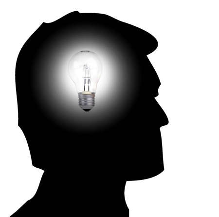 Silhouette of a man with a light bulb on is head to illustrate the concept of having and ideaの写真素材
