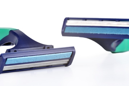Disposable razors on a white background with some reflection underneath