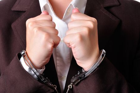 Closeup of an handcuffed businessperson in a brown suit
