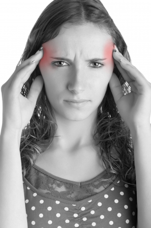 Woman suffering from an headache, holding her hands to the head, isolated in a white backgroundの写真素材