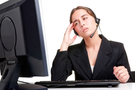 Corporate woman talking over her headset, isolated in a white backgroundの写真素材