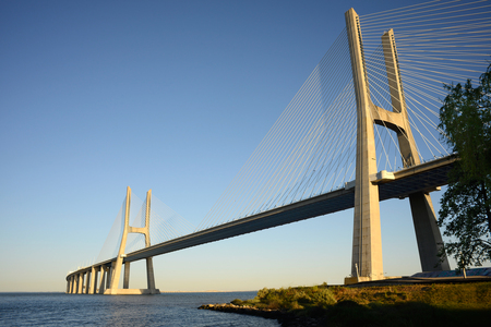 Vasco da Gama bridge at sunset, crossing the Tagus river, in Lisbon, Portugalの写真素材