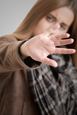 Closeup of a woman protecting herself from an aggressorの写真素材
