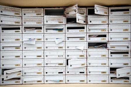 Group of old an damaged mailboxes on a vacant condoの写真素材
