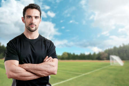 Soccer Trainer, with arms crossed, in a soccer fieldの写真素材
