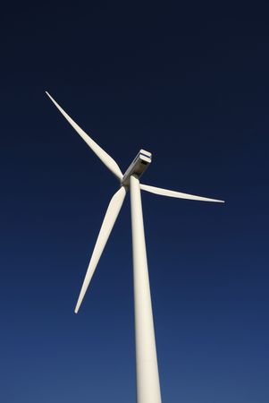 Modern white wind turbine or wind mill producing energy 