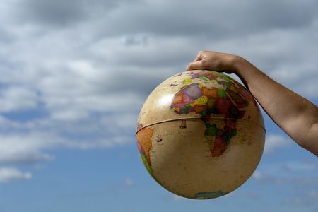 world globe in woman hand and the skyの写真素材