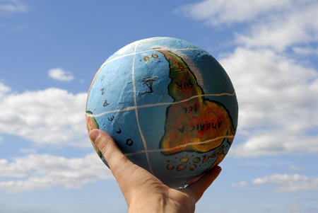 globe in a woman's hand and the skyの写真素材