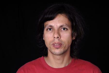 young casual man portrait in black background