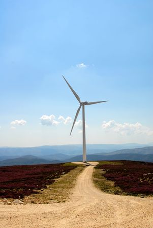 photo of a road with wind turbine on the mountain
