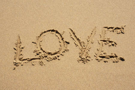 love on the wet sand at the beachの写真素材