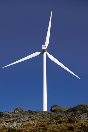 white wind turbine in the top of the mountainの写真素材