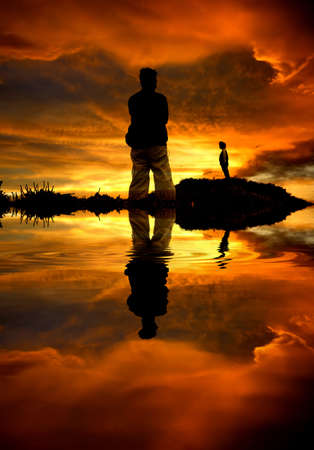 couple separated at sunset in the coastの写真素材