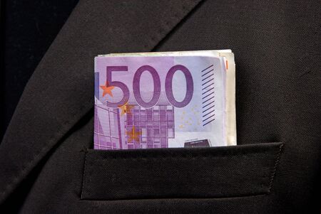 some bank notes in business man pocketの写真素材