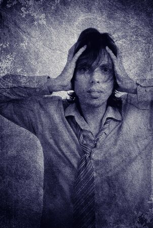 worried young man on a grunge background, computer workの写真素材