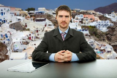 young salesman in a desk with santorini as backgroundの写真素材