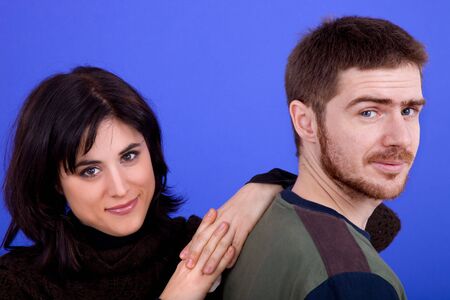 young casual couple together, isolated on blue backgroundの写真素材