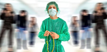 young male doctor with some people on the backの写真素材