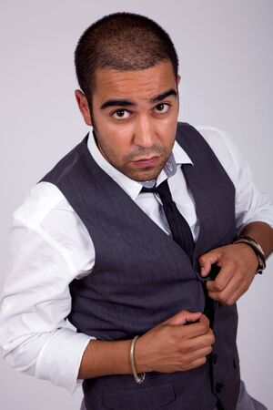 young business man pensive, on a grey background