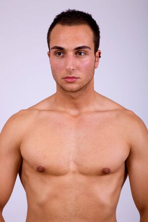young sensual man on a grey backgroundの写真素材