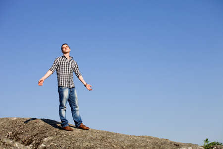 young casual man with the sky as backgroundの写真素材