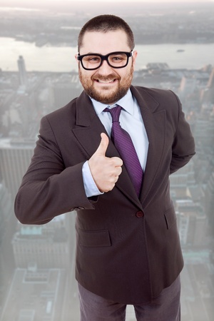 young silly business man going thumb upの写真素材