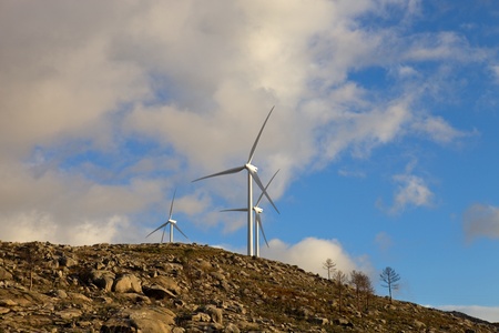 white wind turbines in the top of the mountainの写真素材