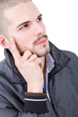 young casual man thinking, isolated on whiteの写真素材