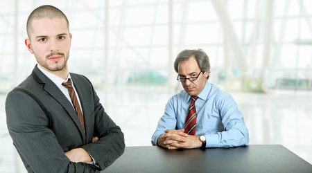two business men on a desk at the officeの写真素材