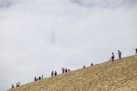 People visiting the Famous dune of Pyla, the highest sand dune in Europe, in Pyla Sur Mer, France.のeditorial素材