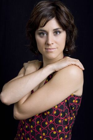 young beautiful brunette portrait against black backgroundの写真素材