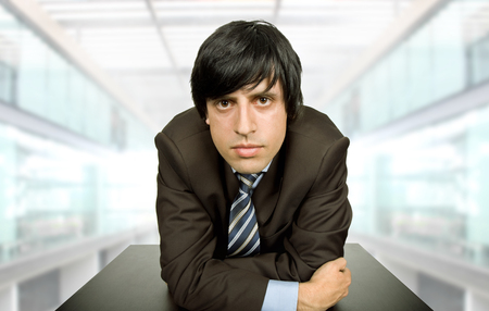 young worried businessman on a desk, at the officeの写真素材