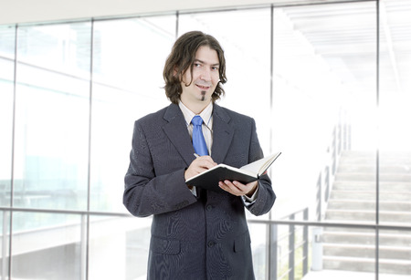 pensive businessman with a book at the officeの写真素材
