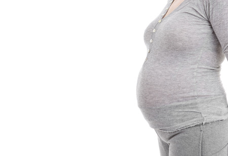 Closeup of pregnant woman at white backgroundの写真素材