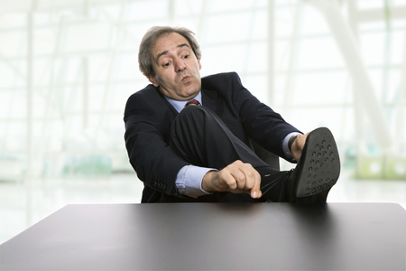 mature business man on a desk at the officeの写真素材