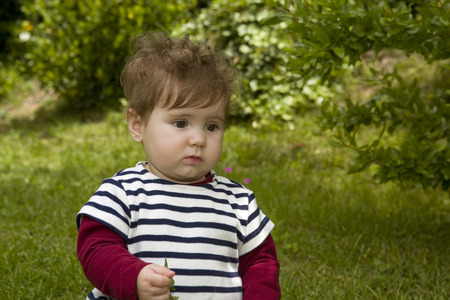 young baby girl at the gardenの写真素材