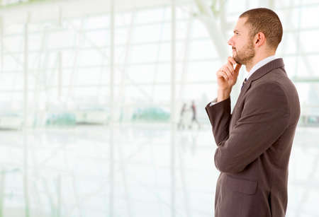 young business man thinking at the officeの写真素材