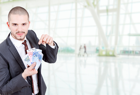 young business man with money at the officeの写真素材